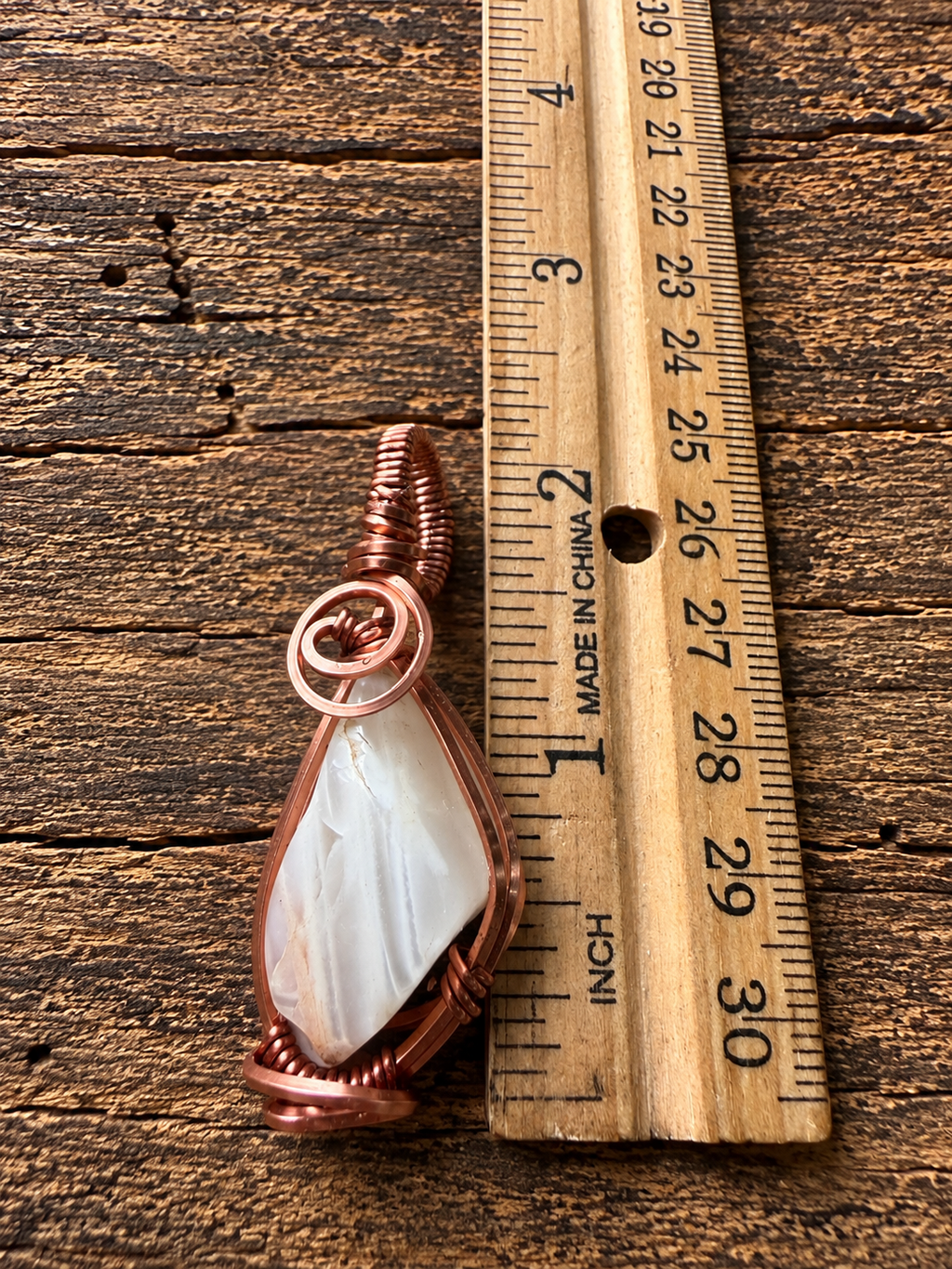 Front view of copper wire-wrapped moonstone pendant