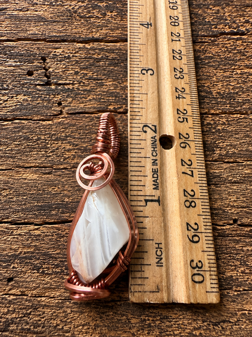 Front view of copper wire-wrapped moonstone pendant
